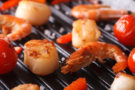 Cooking Scallops, shrimp and vegetables on grill macro. Horizontalの写真素材