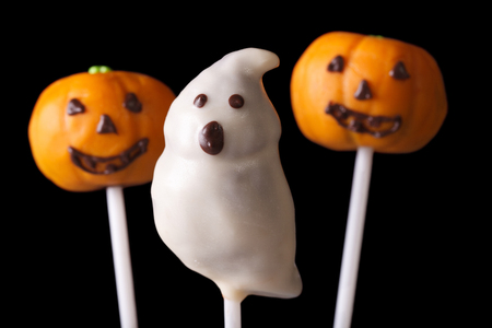 Halloween cake pop spooky and pumpkins isolated on a black background. horizontalの写真素材