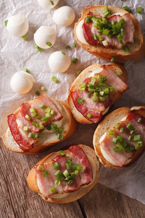 toast with bacon and mozzarella cheese close-up on the table. vertical top viewの写真素材