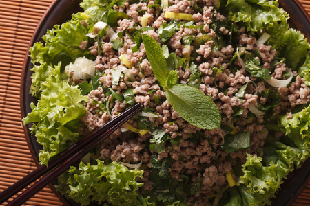 Thai Food: salad of minced meat with herbs macro on a plate. horizontal view from aboveの写真素材