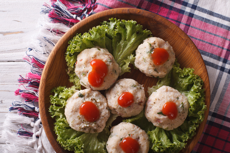canederli with tomato sauce closeup on a wooden plate. horizontal view from aboveの写真素材