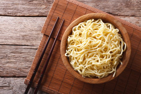 Asian ramen noodles in wooden bowl on the table. horizontal view from aboveの写真素材