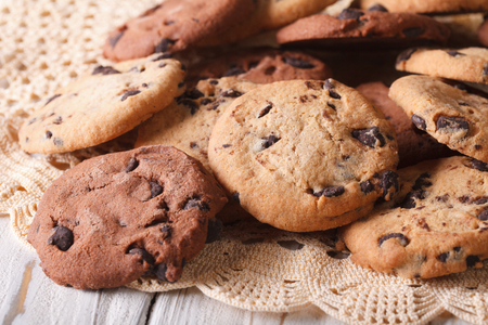 A pile of homemade chocolate chips cookies closeup on a wooden table. horizontalの写真素材