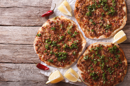 Asian pizza lahmacun on a wooden table. horizontal view from aboveの写真素材