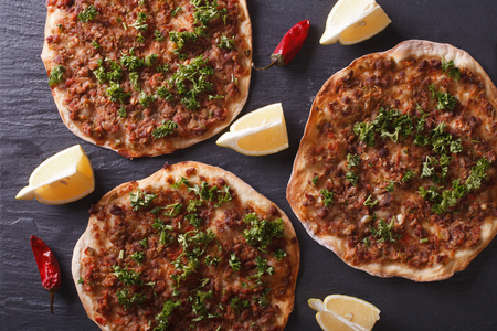 Delicious Turkish pizza lahmacun closeup on a stone table. Horizontal top viewの写真素材