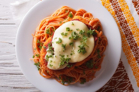 Italian chicken Parmigiana and pasta close up on a plate on the table. horizontal top viewの写真素材