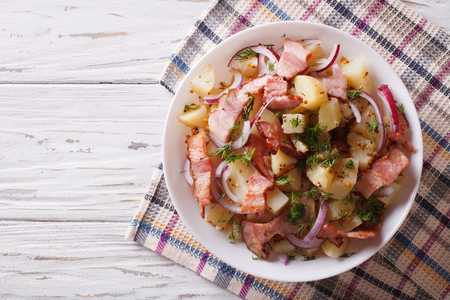 Potato salad with bacon and onions in a bowl. Horizontal top viewの写真素材