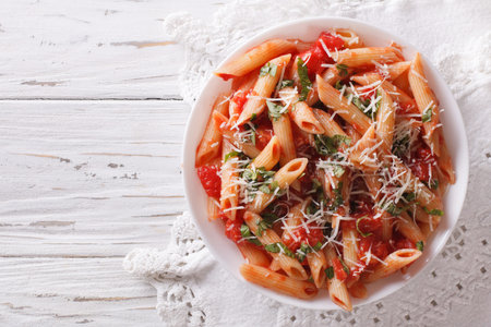 Arrabiata pasta penne with Parmesan cheese on a plate. horizontal top viewの写真素材