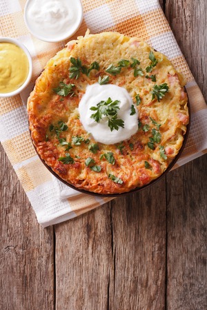 Potato pancakes with sauce and parsley on a plate on the table. vertical top viewの写真素材