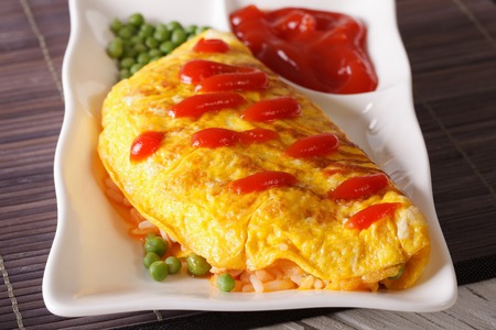 Delicious Japanese omelet stuffed with rice and chicken close-up on a plate. horizontalの写真素材