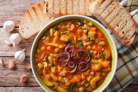 Tuscan ribollita soup close up in a bowl on the table. horizontal view from aboveの写真素材