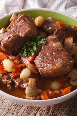Beef Burgundy close-up in a bowl on the table. verticalの写真素材