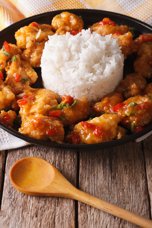 Orange chicken fillet with sauce and rice closeup on a plate. Verticalの写真素材