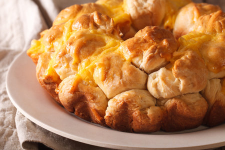 Homemade monkey bread with cheese macro on a plate on the table. horizontal