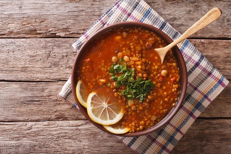Thick Moroccan Harira soup in a bowl close-up on the table. Horizontal view from aboveの写真素材