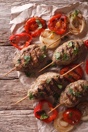 Kofta kebab with grilled vegetables close-up on the table. vertical view from aboveの写真素材