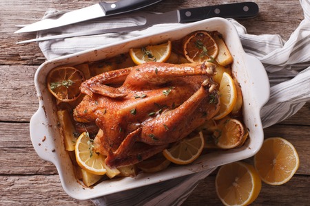 Lemon chicken with thyme and potato close up in a baking dish. horizontal view from aboveの写真素材