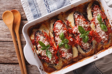 Italian eggplant Melanzane alla parmigiana close up in baking dish on the table. horizontal view from aboveの写真素材