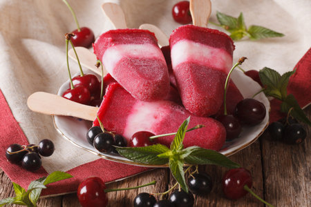 Tasty berry ice cream with mint close up on a stick on the table. Horizontalの写真素材