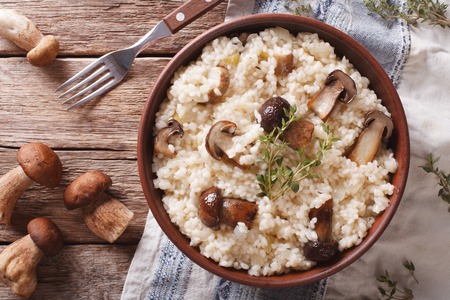 risotto with porcini mushrooms and thyme close-up on the plate. Horizontal view from aboveの写真素材