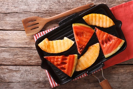 Ripe Healthy Organic Grilled Watermelon and melon close-up on the table. Horizontal view from aboveの写真素材