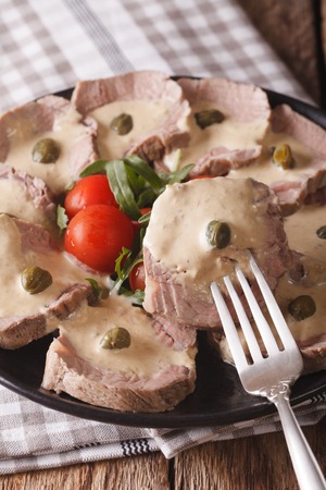 Italian beef with tuna sauce on a plate close-up. verticalの写真素材