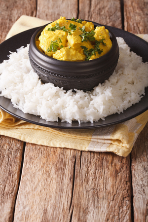 Indian Cuisine: Korma chicken in coconut sauce and basmati rice close-up on the table. verticalの写真素材