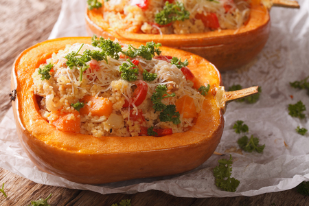 Baked pumpkin stuffed with couscous, meat and cheese close-up on the table. horizontalの写真素材