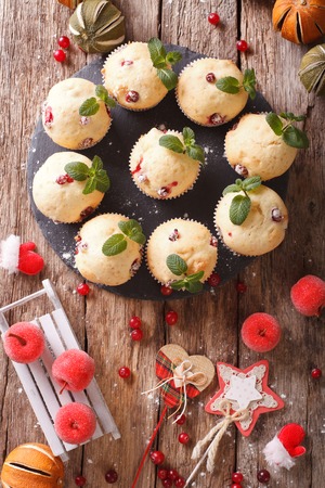 Christmas cranberry muffins decorated with mint close up on the table. vertical view from above
の写真素材