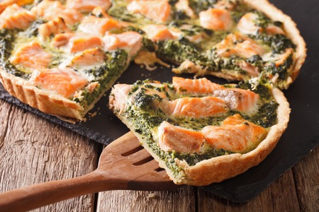 Sliced tart with salmon, spinach and cream close-up on the table. horizontal
の写真素材