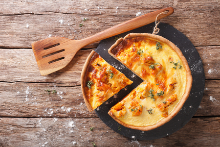 Savory pie with pumpkin, cheese, chicken and herbs closeup on the table. Horizontal view from above
の写真素材