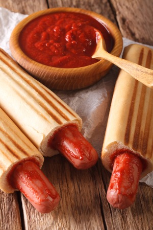 Spicy French hot dog rolls with ketchup closeup on the table. vertical
の写真素材