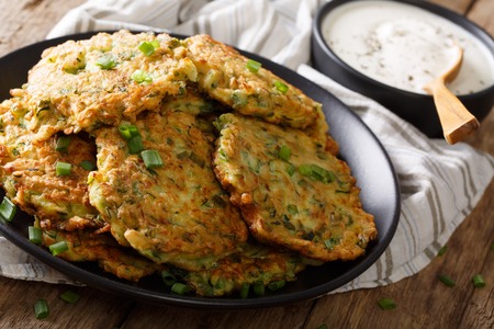 Freshly cooked Zucchini pancakes with sour cream close-up on the table. horizontalの写真素材