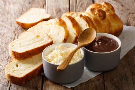 sliced fresh brioche bread and cream cheese, chocolate cream close-up on the table. horizontalの写真素材