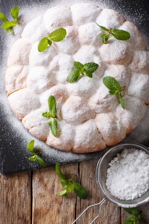 sweet Austrian rolls buchteln with powdered sugar close-up on the table. Vertical top view from above
の写真素材