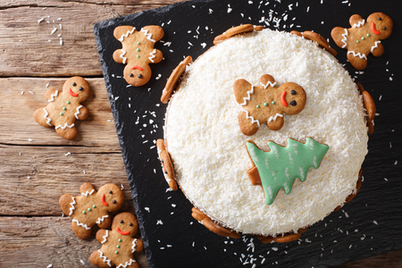 Christmas sweet cake with cheese cream and gingerbread close-up on the table. horizontal top view from aboveの写真素材