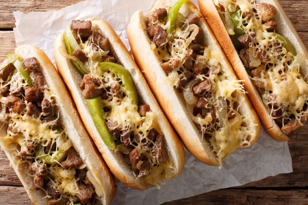 Philadelphia cheesesteak sandwich close-up on paper on the table. Horizontal top view from above
の写真素材