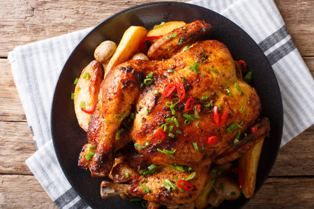 grilled chicken with fried mushrooms and potatoes close-up on a plate. horizontal top view from...