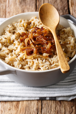 Arabic cuisine: rice with lentils and fried onions close-up in a bowl on the table. vertical
の写真素材