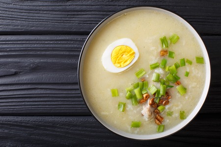Arroz Caldo soup with rice, chicken and egg close-up in a bowl. horizontal top view from above
の写真素材
