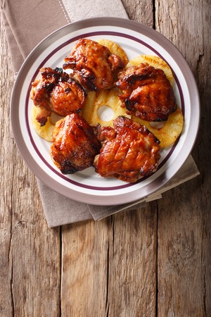 Hawaiian BBQ huli huli: Grilled chicken glazed with pineapple close-up on a plate. Vertical top view from above
の写真素材