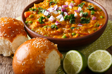 Pav Bhaji is a fast food dish from India, Thick and spicy vegetable curry, fried and served with a soft bread roll Bun Paav on the table. horizontal
の写真素材