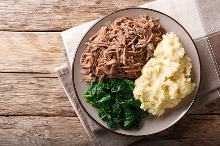 Botswana cuisine: seswaa beef stew with pap porridge and spinach close-up on a plate on a table. horizontal top view from above
の写真素材