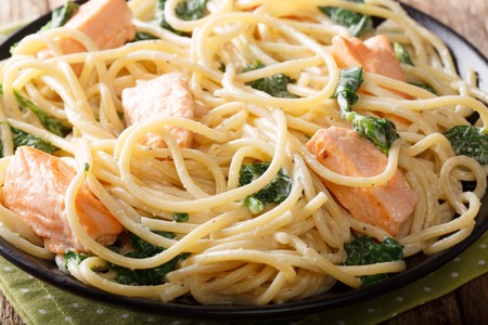 Delicious spaghetti pasta with salmon and spinach closeup on a plate on the table. horizontal
の写真素材