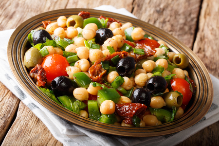 East balela salad with chickpeas, tomatoes, onions, olives and herbs closeup on a plate. horizontal, rustic
の写真素材
