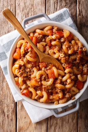 Homemade American goulash with elbow pasta, beef and tomatoes close-up in a saucepan. Vertical top view from above
の写真素材