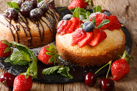Delicate cakes with chocolate, mint and strawberries, cherries and blueberries close-up on the table. horizontal,
の写真素材