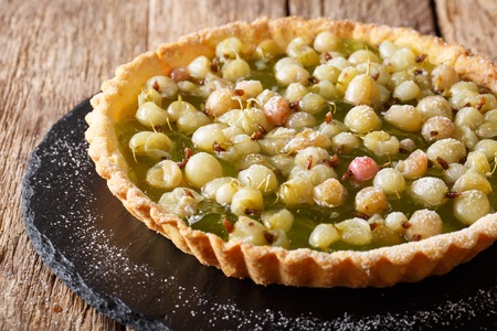 Sweet tart with gooseberries and jam close-up on the table. horizontalの写真素材