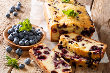 fresh blueberry loaf of bread muffin cake with mint closeup on a table. horizontalの写真素材