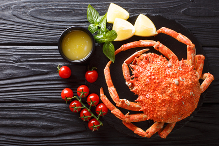 Delicious crab spider served with lemon and melted butter close-up on the table. Horizontal top view from aboveの写真素材